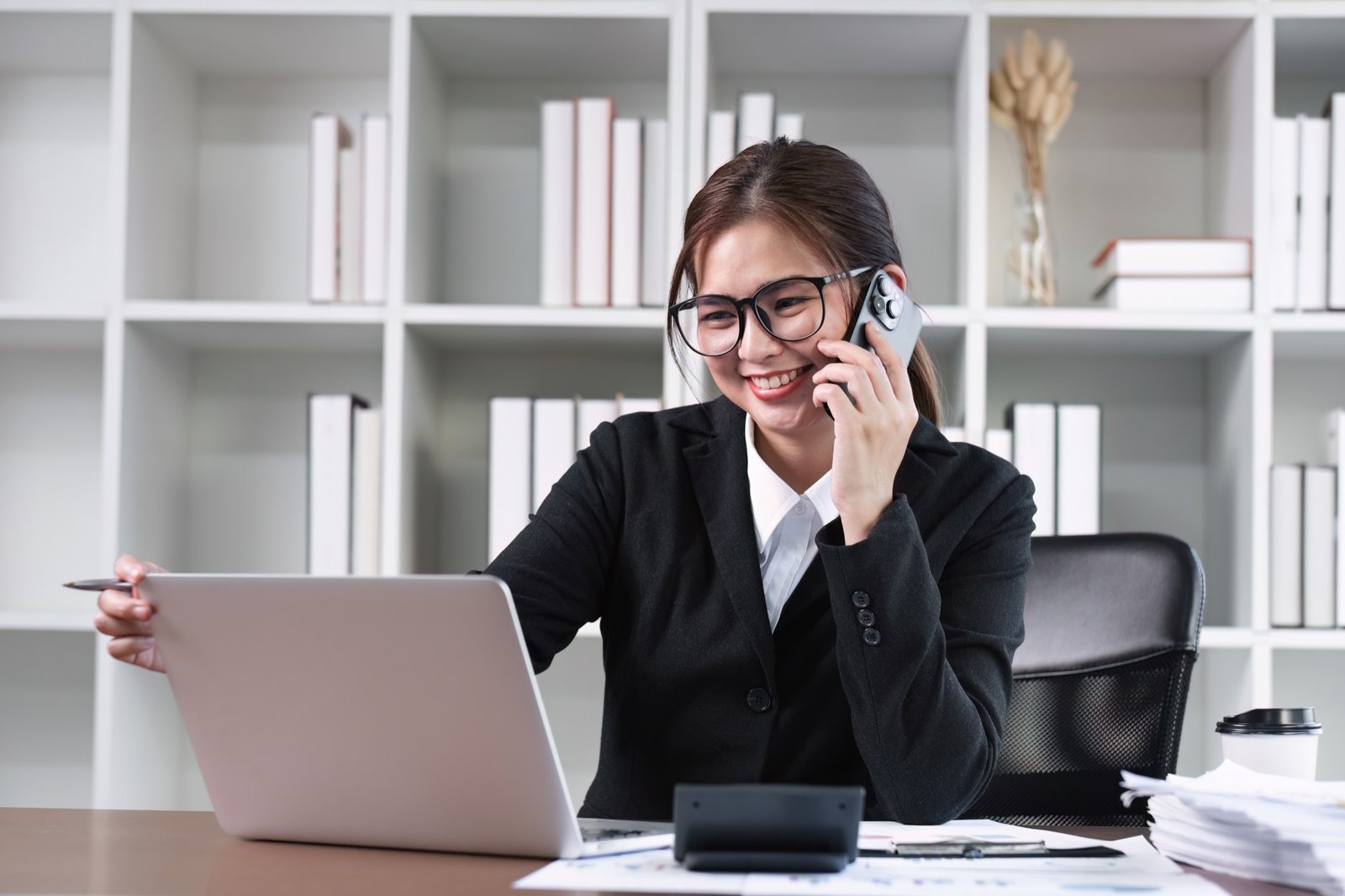 Business advisor speaking with a customer while working from a laptop